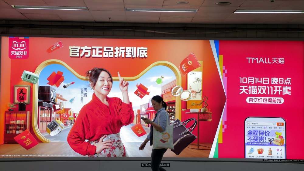 A pedestrian walks by advertisement promoting Tmall's Singles' Day Shopping Festival in Shanghai, China.