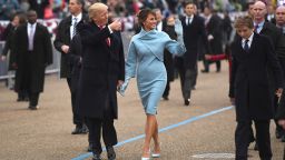 TOPSHOT - US President Donald Trump and First Lady Melania walk the inaugural parade route with son Barron (R) on Pennsylvania Avenue in Washington, DC, on January 20, 2017 following swearing-in ceremonies on Capitol Hill earlier today. (Photo by JIM WATSON / AFP) (Photo by JIM WATSON/AFP via Getty Images)