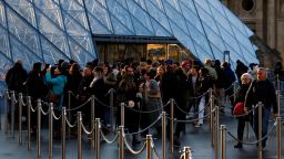 Tourists queue near the glass Pyramid entrance of the Louvre Museum in Paris, France, on January 23, 2025.