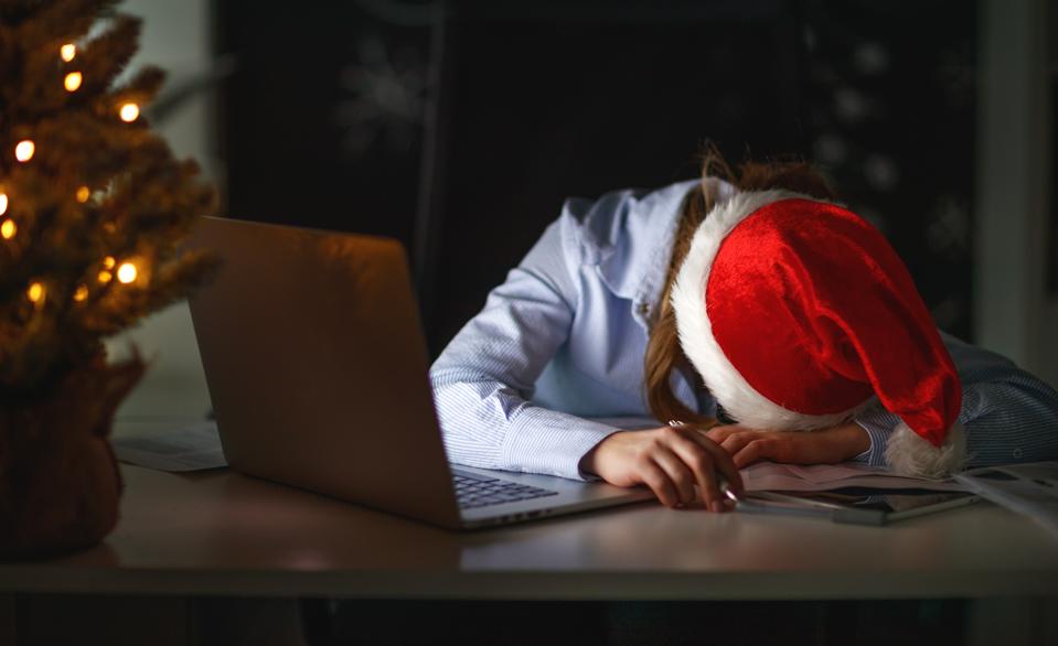 businesswoman freelancer tired, asleep working at computer at Christmas